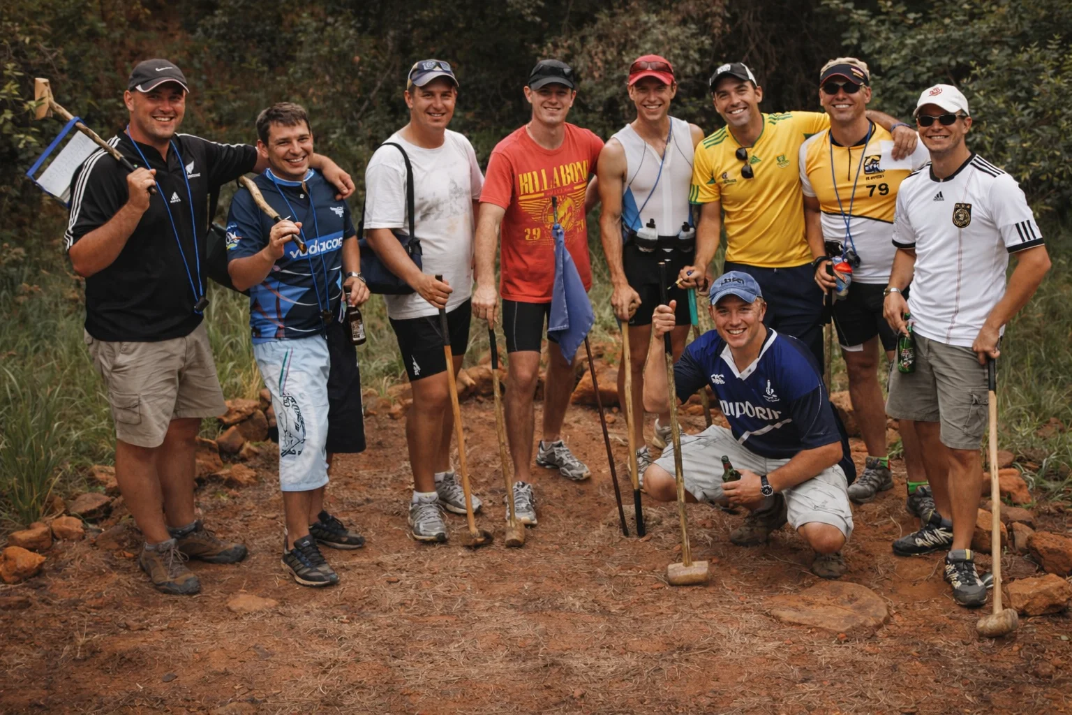 Group of friends posing with traditional knobkierries during an ancient golf round on the mountain.